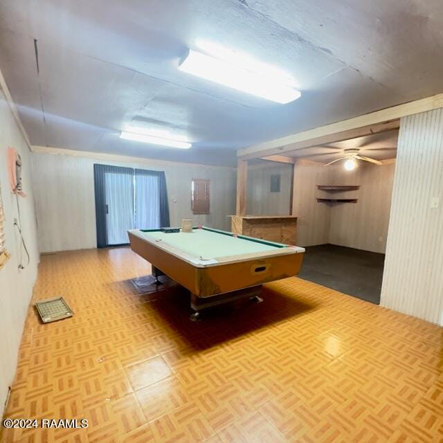 rec room with light parquet flooring, billiards, ceiling fan, and wood walls