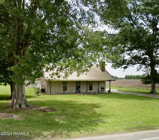 view of front of house with covered porch and a front yard