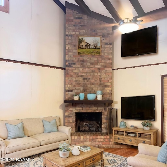 living room with a fireplace, hardwood / wood-style flooring, and high vaulted ceiling