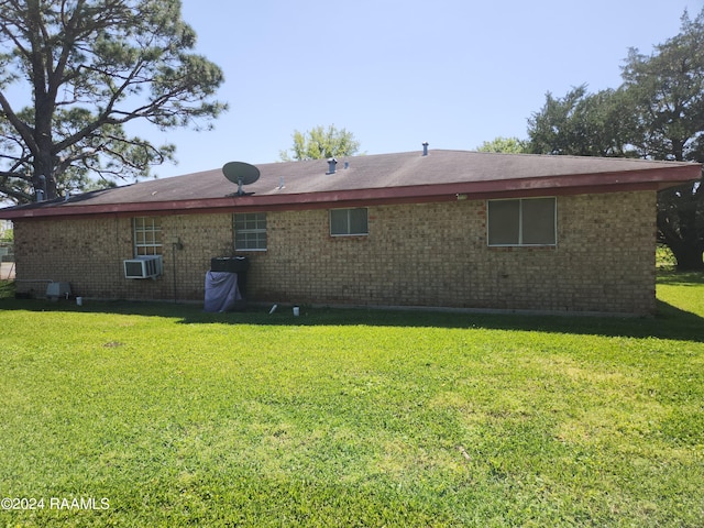 back of house with a lawn