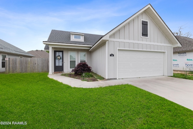 view of front of property with a front yard and a garage