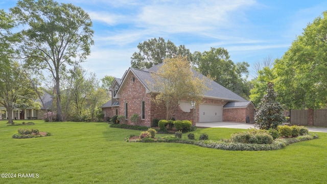 view of front of house featuring a front yard and a garage