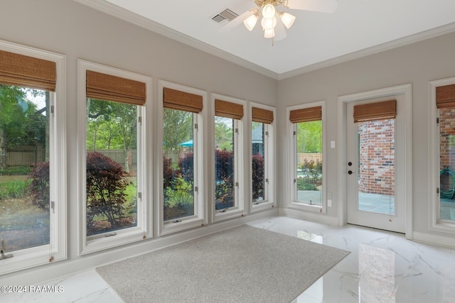 unfurnished sunroom with ceiling fan