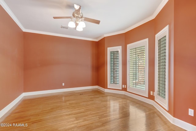 empty room featuring light hardwood / wood-style floors, ceiling fan, and crown molding