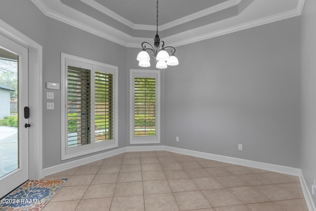 tiled empty room featuring a chandelier, a raised ceiling, and crown molding