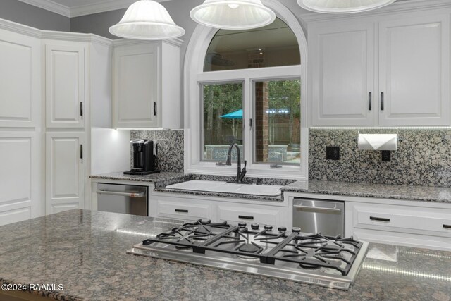 kitchen with dark stone counters and white cabinetry