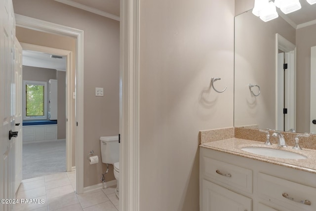 bathroom with crown molding, toilet, tile floors, and large vanity