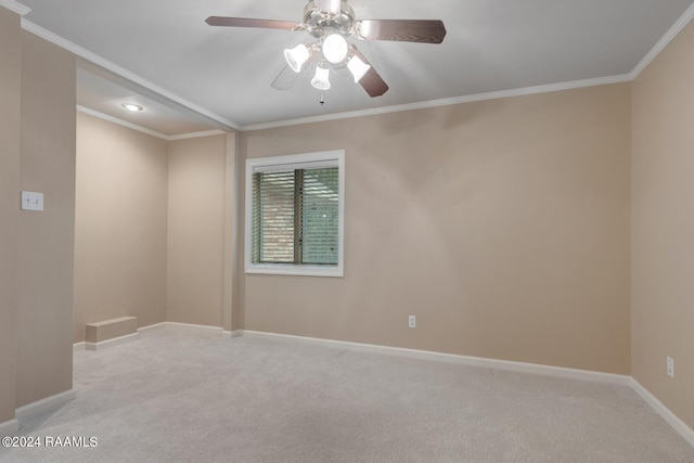 carpeted empty room featuring crown molding and ceiling fan