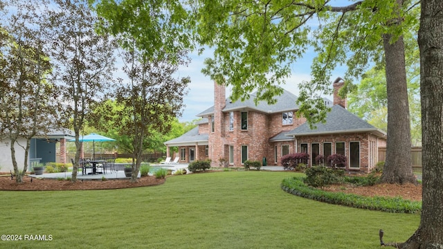 view of front of house featuring a front yard and a patio