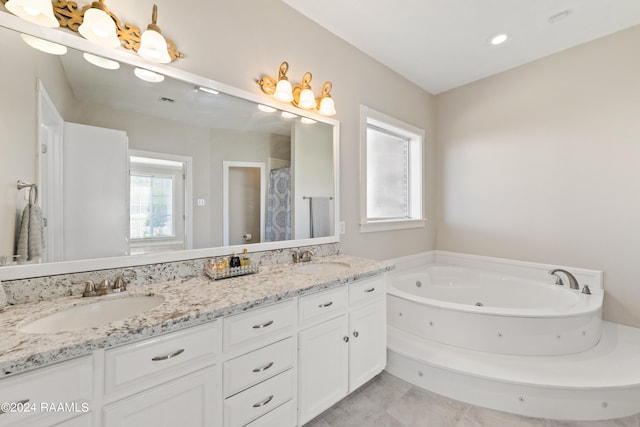 bathroom featuring a washtub, vanity, and tile patterned flooring