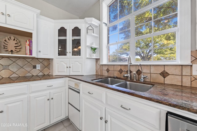 kitchen featuring backsplash, white cabinetry, and sink