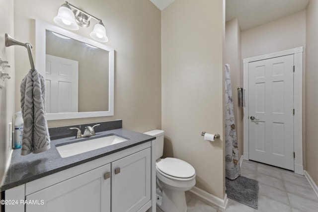 bathroom with tile patterned floors, vanity, and toilet