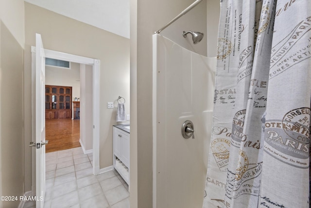 bathroom with hardwood / wood-style floors, vanity, and curtained shower