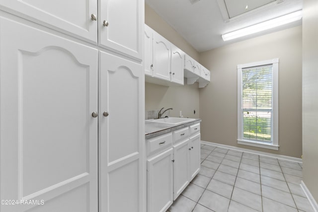 kitchen featuring sink, white cabinets, and light tile patterned floors