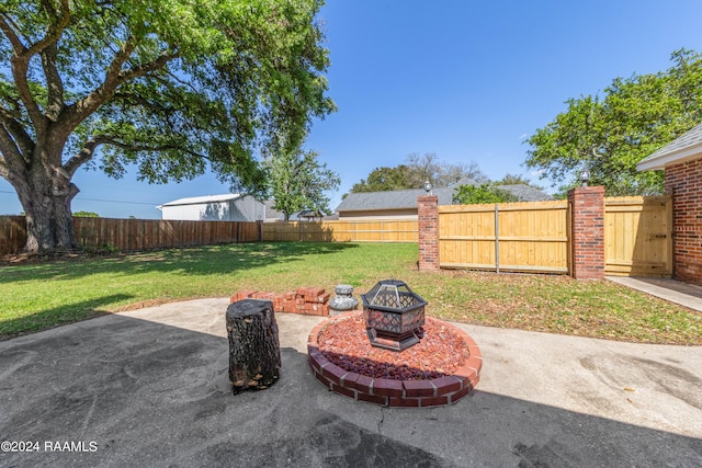 view of yard featuring a patio and a fire pit