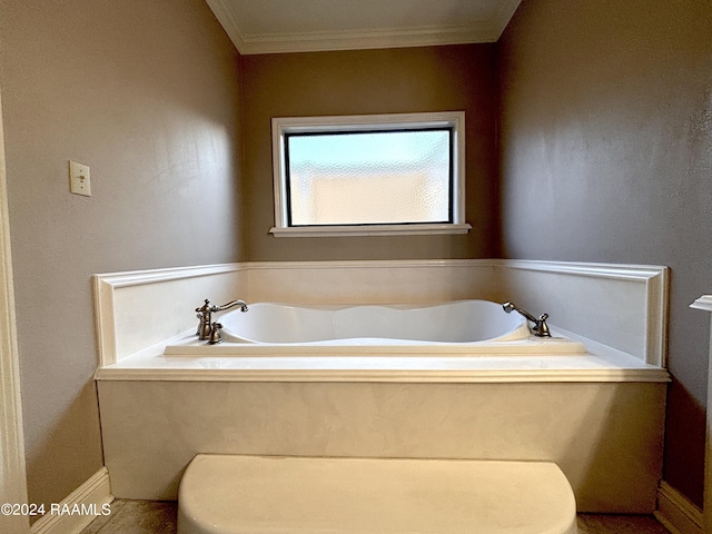 bathroom with a tub and ornamental molding