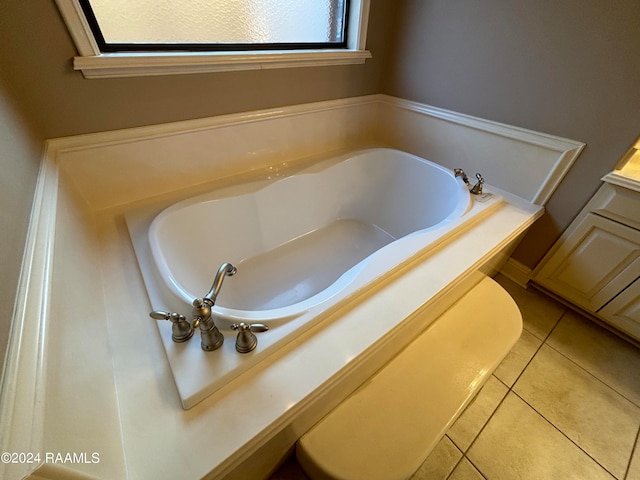 bathroom featuring a tub and tile floors