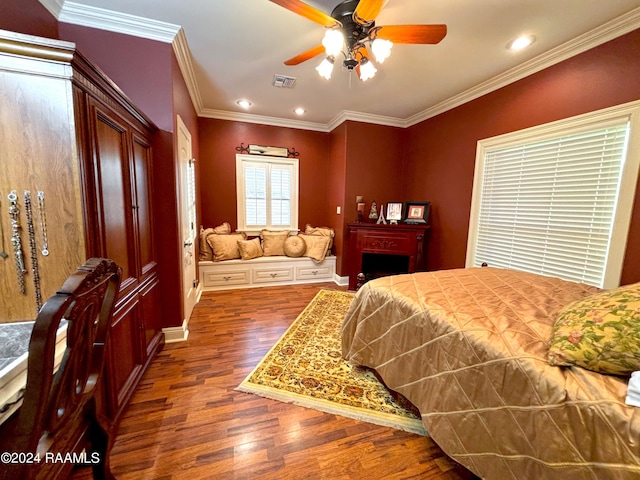 bedroom with ceiling fan, crown molding, and dark wood-type flooring