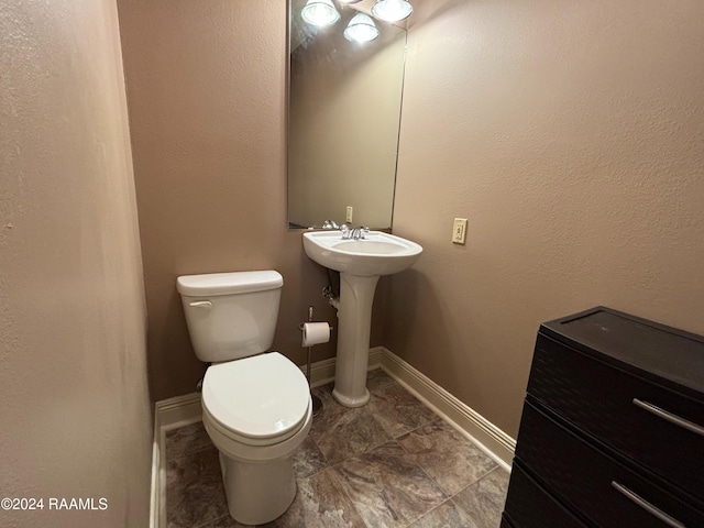 bathroom featuring tile flooring, toilet, and sink