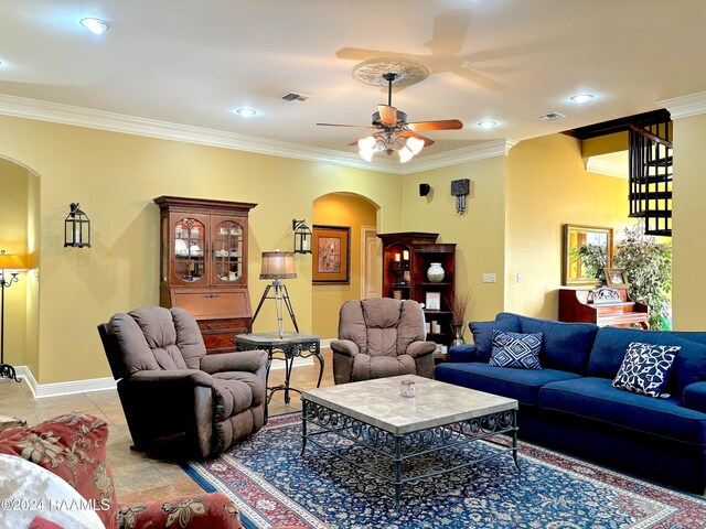 tiled living room featuring ceiling fan and ornamental molding