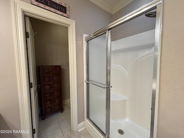 bathroom featuring tile floors, an enclosed shower, and crown molding