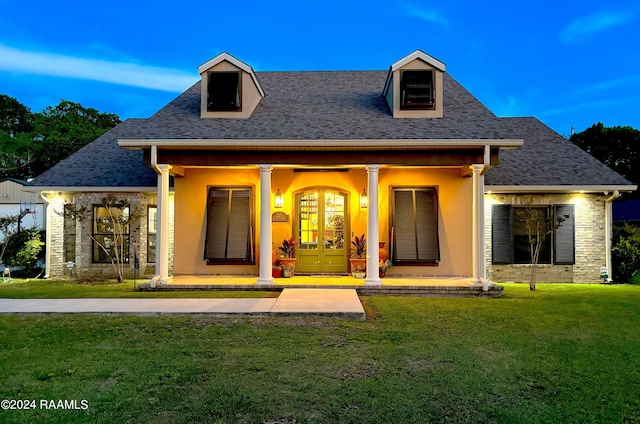 exterior space featuring a lawn and covered porch