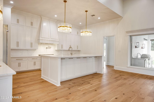 kitchen featuring white cabinets and light wood-type flooring