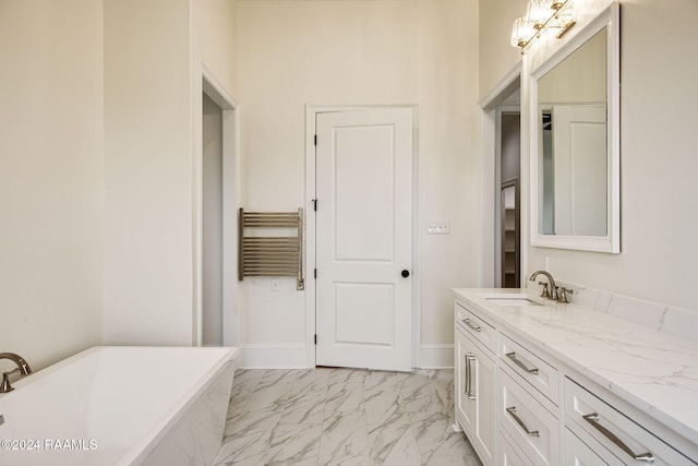 bathroom with a tub, vanity, and radiator heating unit