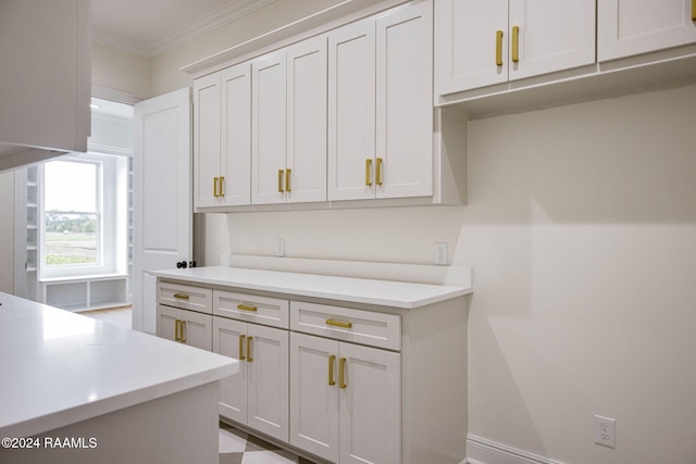 kitchen with white cabinetry and crown molding