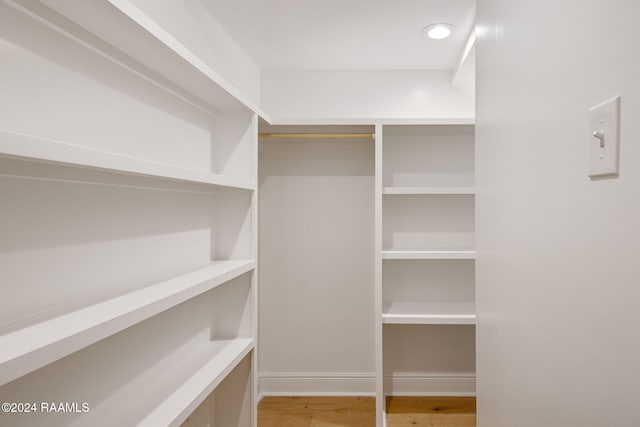 spacious closet featuring hardwood / wood-style flooring