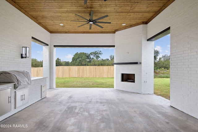 view of patio / terrace featuring grilling area, an outdoor brick fireplace, and ceiling fan