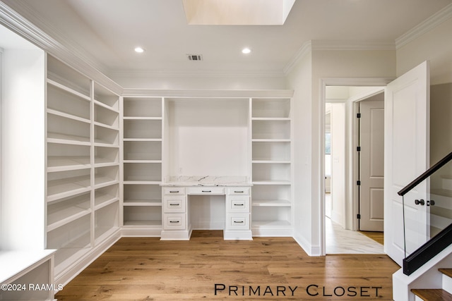 walk in closet with light wood-type flooring