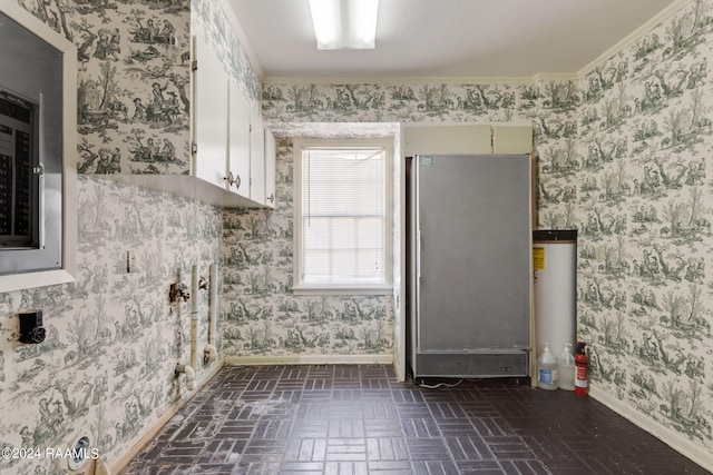 interior space featuring white cabinets, water heater, crown molding, and stainless steel fridge