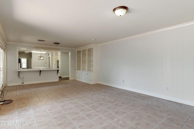 empty room with light tile flooring and crown molding