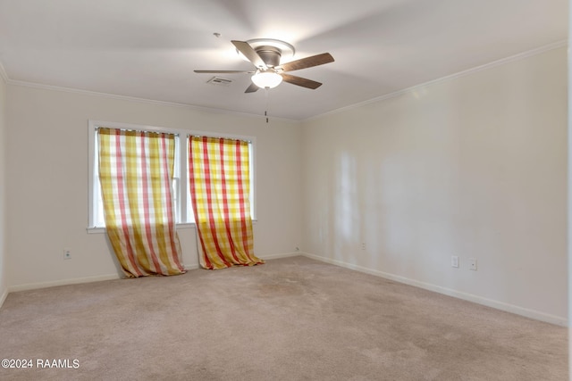 carpeted empty room with ornamental molding and ceiling fan