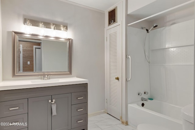 full bathroom featuring oversized vanity, crown molding, toilet, tiled shower / bath, and tile floors