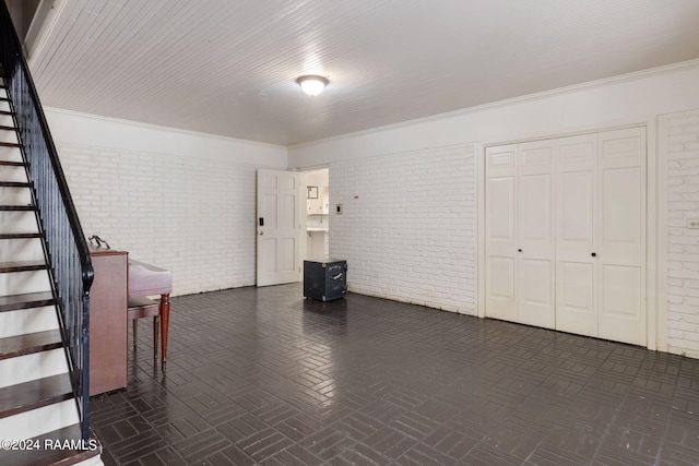 interior space with brick wall and ornamental molding