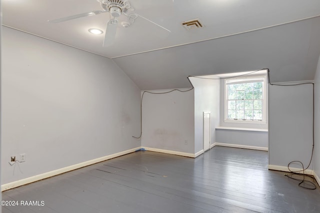 empty room with dark hardwood / wood-style flooring, ceiling fan, and lofted ceiling