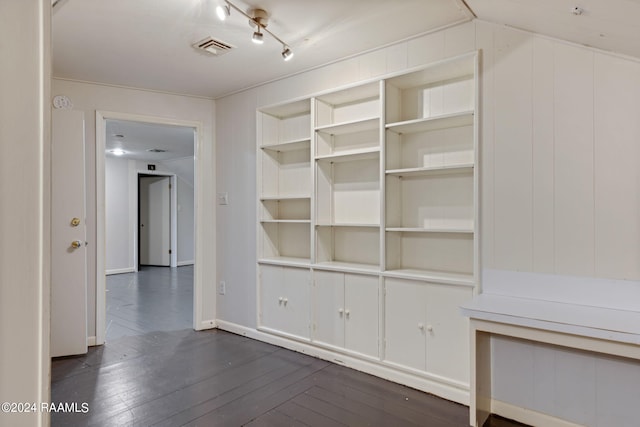 interior space with rail lighting and dark hardwood / wood-style floors