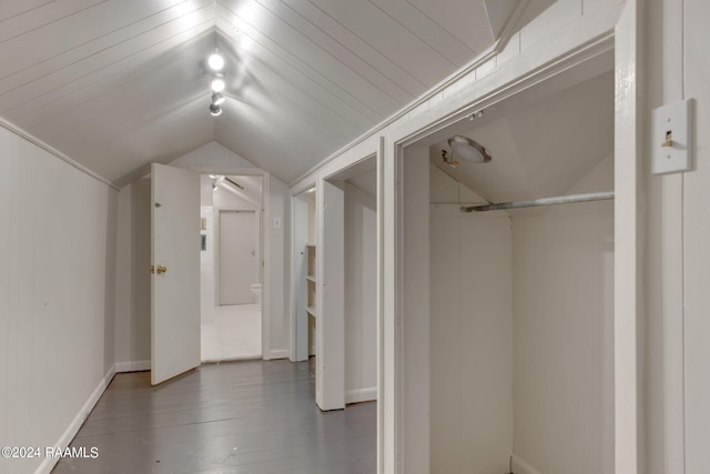 hall featuring lofted ceiling and dark wood-type flooring