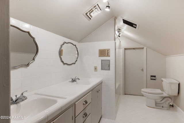 bathroom with tile flooring, tile walls, and vaulted ceiling