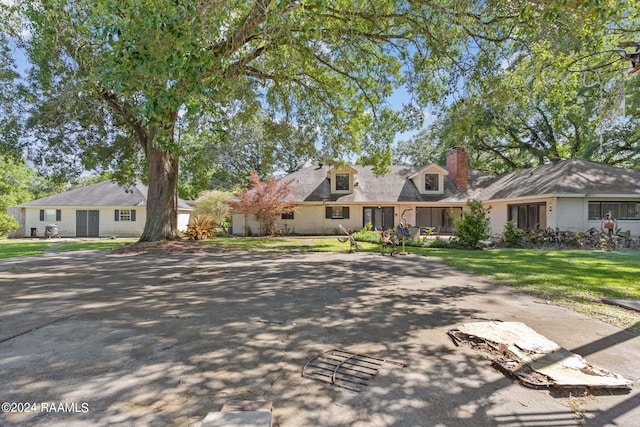 cape cod home with a front yard