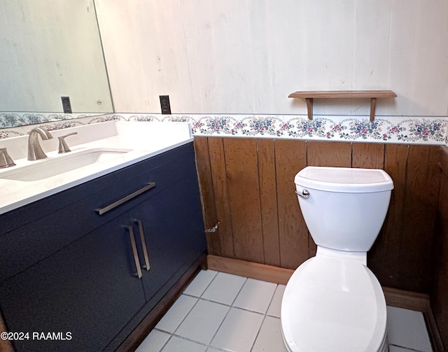 bathroom with toilet, tile flooring, and vanity