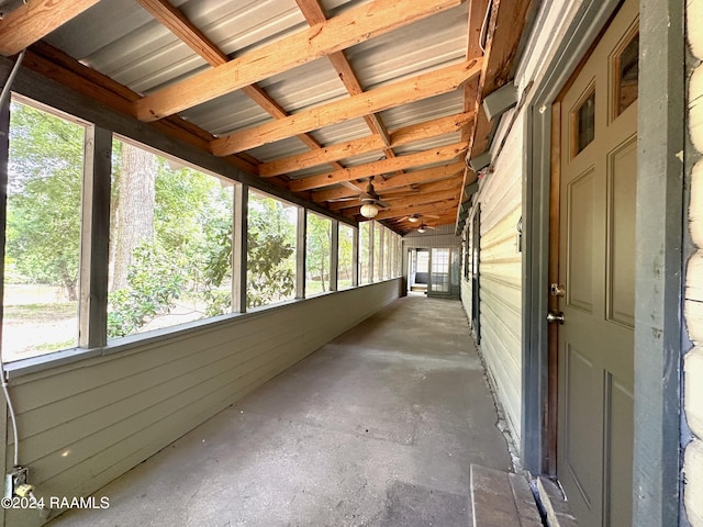 unfurnished sunroom with ceiling fan