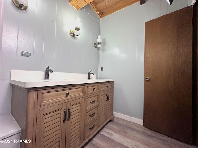 bathroom with wood ceiling, hardwood / wood-style floors, and dual bowl vanity