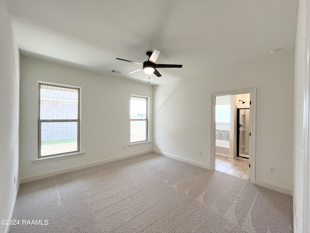 carpeted spare room featuring ceiling fan