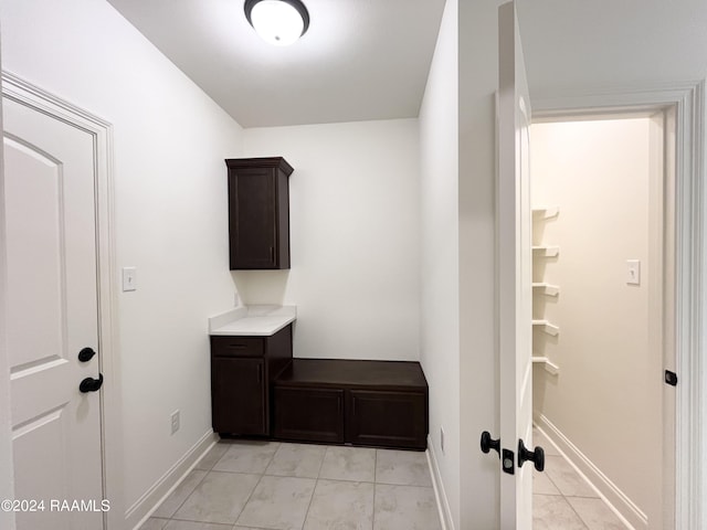 laundry area featuring light tile patterned flooring