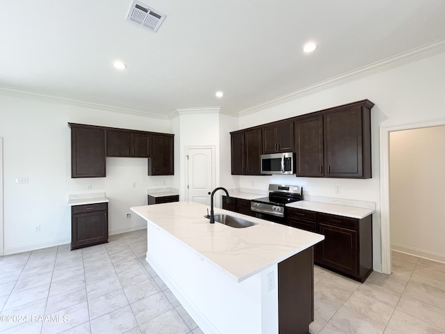 kitchen featuring sink, stainless steel appliances, light stone counters, a kitchen island with sink, and ornamental molding