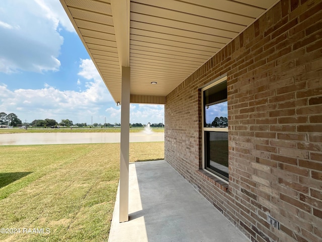 view of patio with a water view