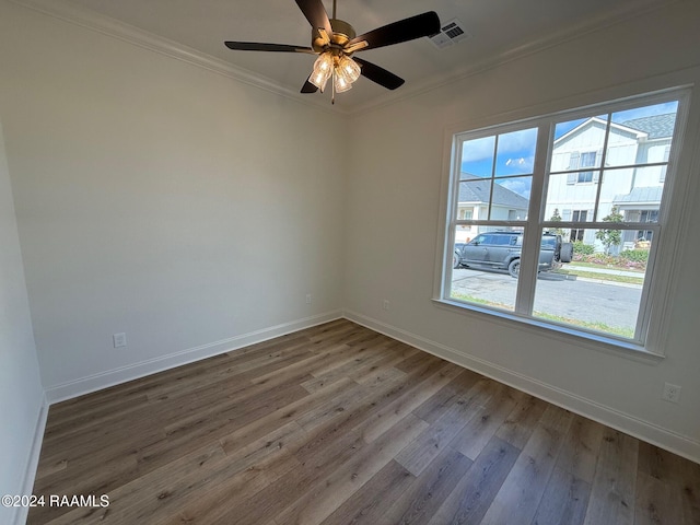 empty room with hardwood / wood-style flooring, ceiling fan, and ornamental molding